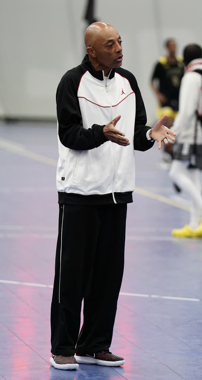 Coach Willie Diggs instructing players in the gym